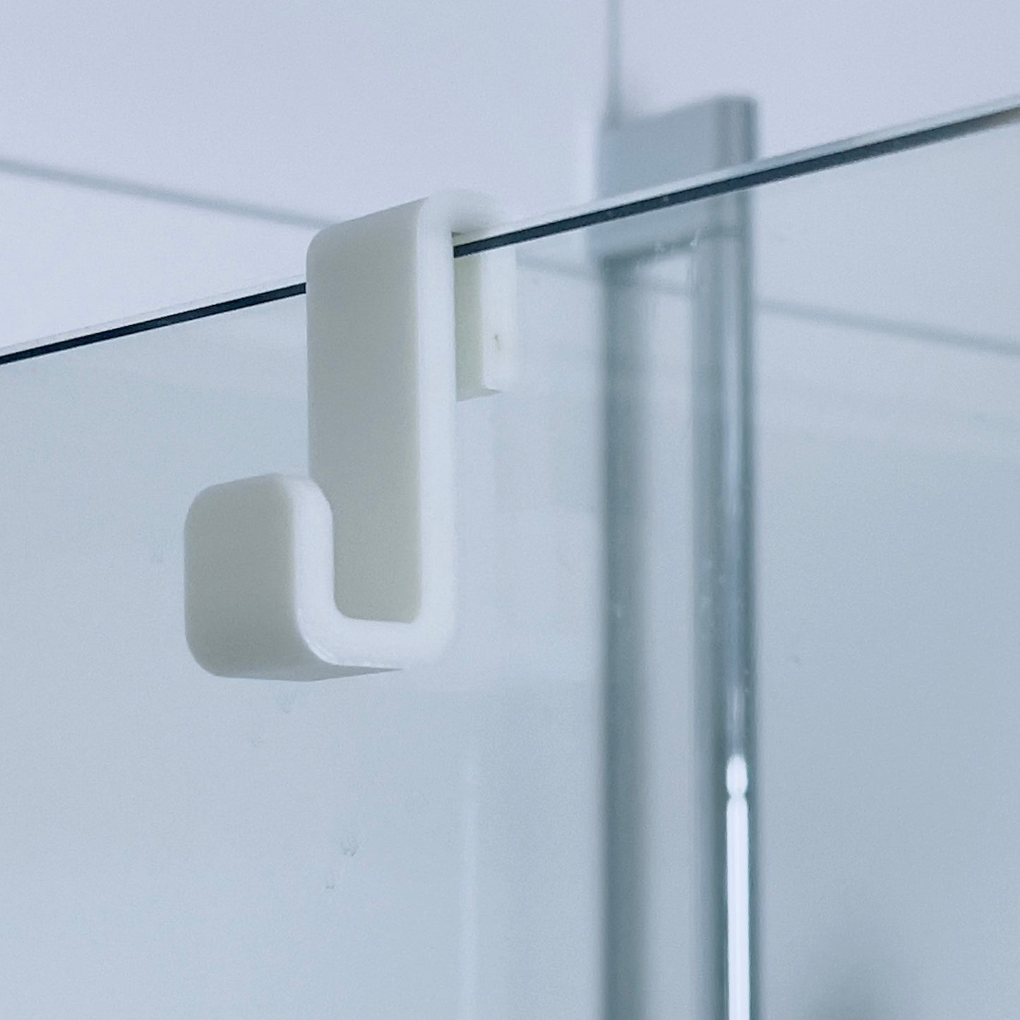 Bathroom towel hanger for glass wall