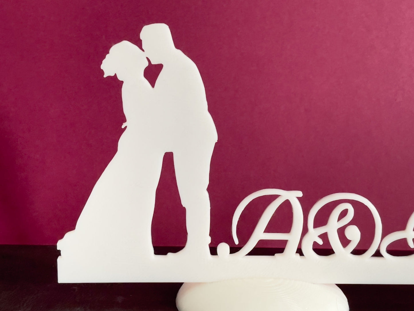 Wedding stand with kissing couple and names initials