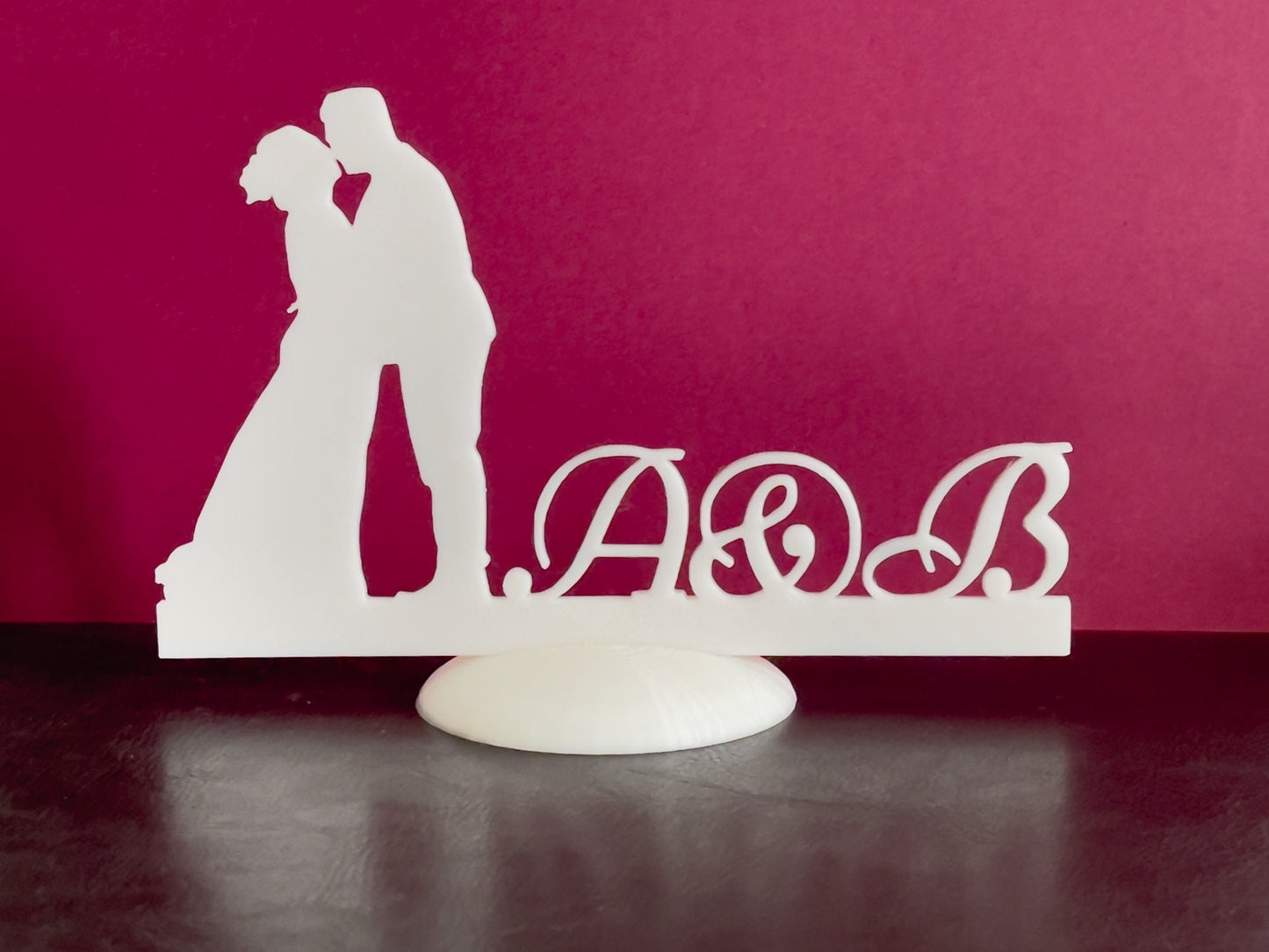 Wedding stand with kissing couple and names initials